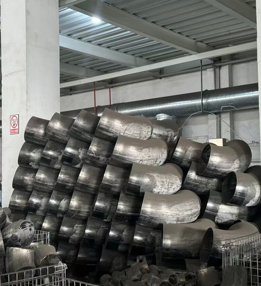 Raw stainless steel elbows after forming