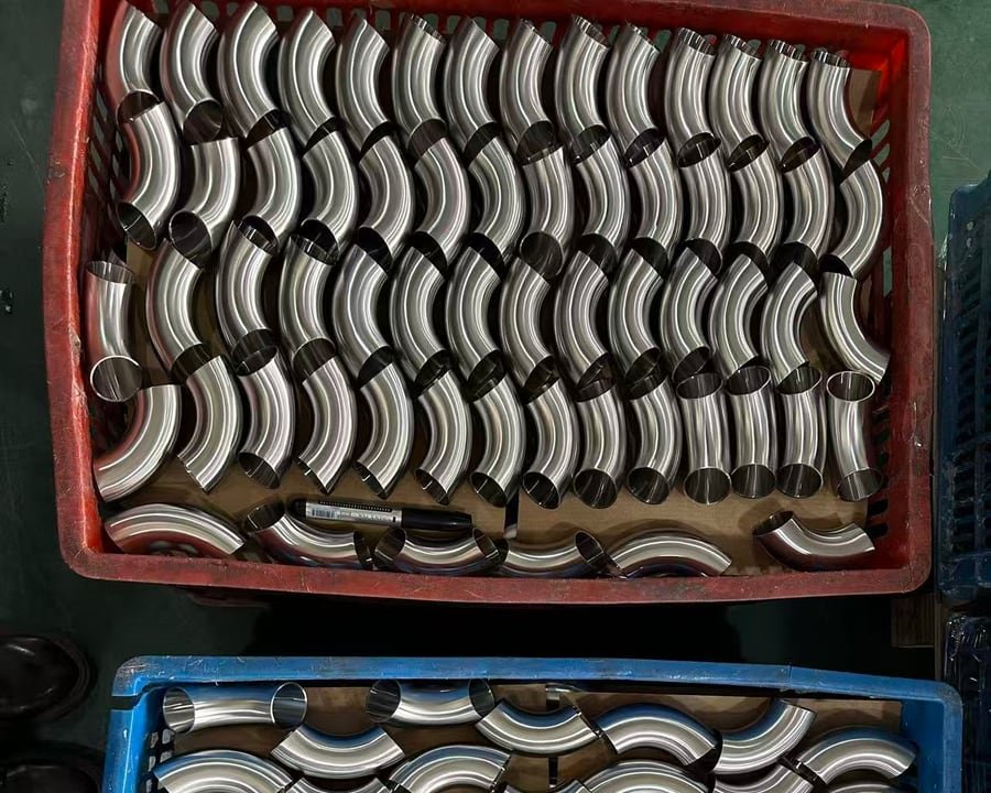 Formed stainless steel elbows arranged in production batches